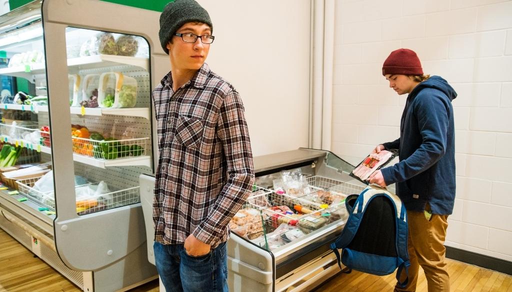 Shoplifting: Why People Steal and How To Prevent It Teenagers retail shoplifting bacon at a grocery store.