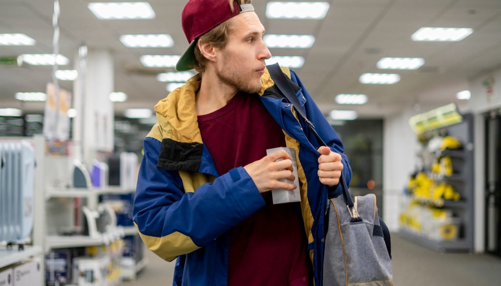 Man shoplifting in a retail store.