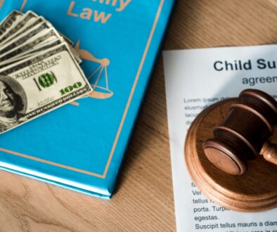 Child support agreement with a pile of cash on a family law book.