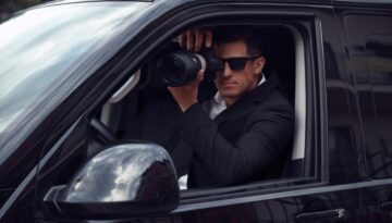 Private Investigator sits in car and takes pictures.