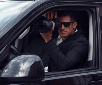 Private Investigator sits in car and takes pictures.