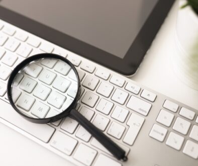 Magnifying glass on a keyboard.