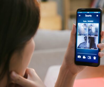 Woman watching a live video home security monitor on her phone.