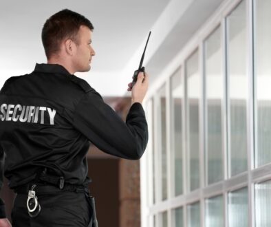 Uniformed security guard patrolling the halls of a building.