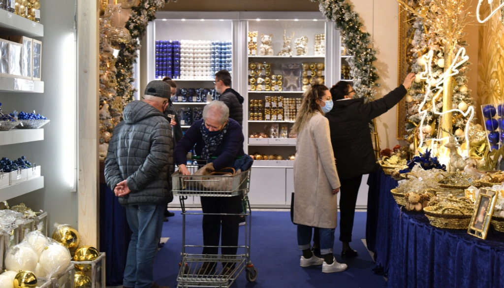 Shoppers browsing for holiday decorations at a retail store.