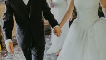 Bride and groom holding hands during wedding reception.