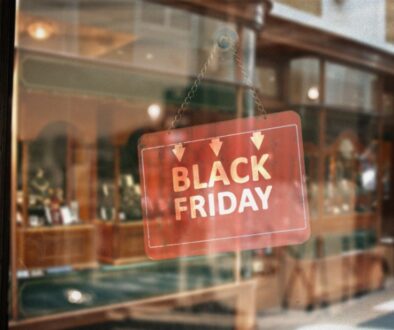 A retail store with a Black Friday sign hung on their door.