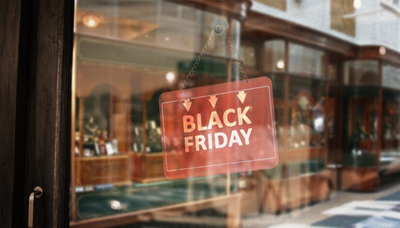 A retail store with a Black Friday sign hung on their door.