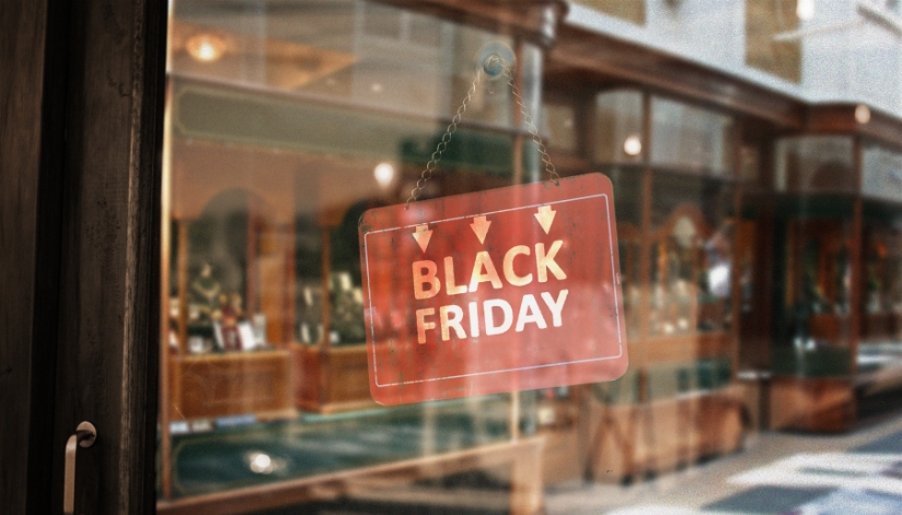 A retail store with a Black Friday sign hung on their door.
