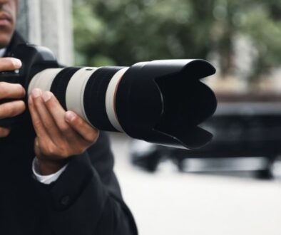 o'brien-&-associates-private-investigator-proces-man-holds-camera-photo-van