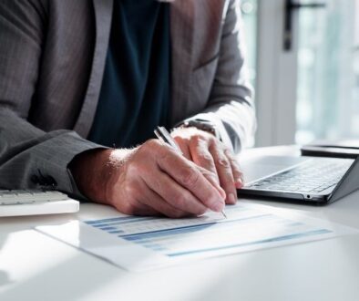 o'brien-&-associates-why-accurate-record-keeping-is-important-man-writing-on-form-information-computer-calculator