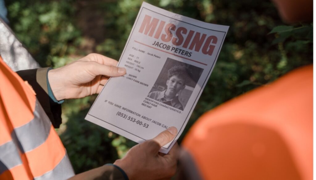 Search team holding a missing person flyer.
