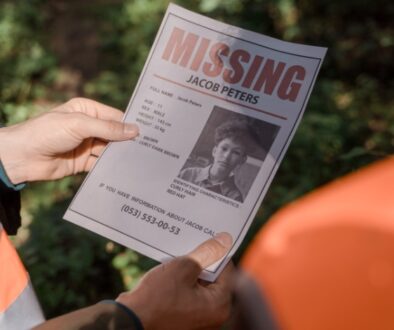 Search team holding a missing person flyer.