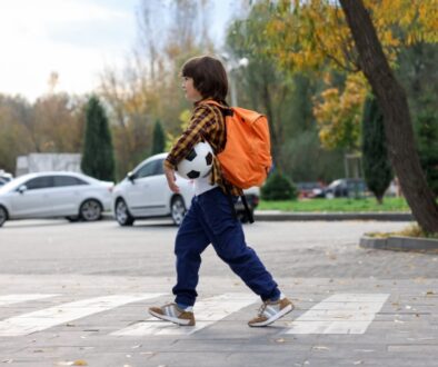 Young boy following back to school safety tips and walking to school.