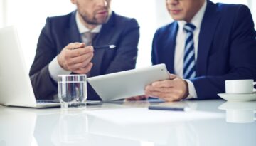 A security professional goes over a security consultation with a business owner.