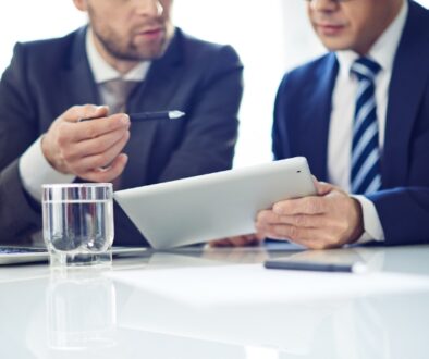 A security professional goes over a security consultation with a business owner.