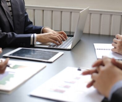 Business employees gather around a table and do their due diligence before making a business decision.
