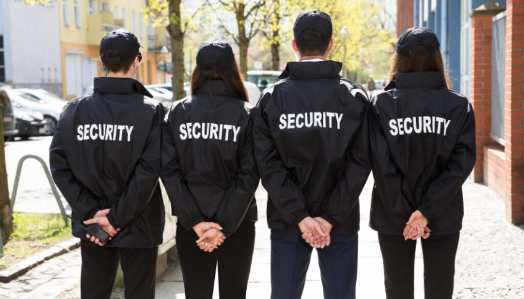Four security guards stand as event security services for a special event.