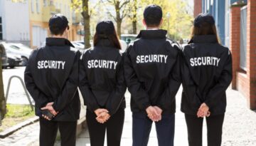 Four security guards stand as event security services for a special event.