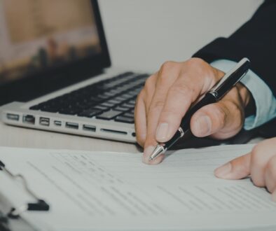 Business owner reviews security preparedness of documents on a clipboard.